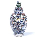 AN ANTIQUE DUTCH DELFT HEXAGONAL VASE with green, blue and red glazed foliate decoration, by