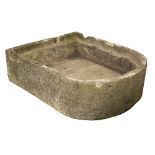 A LARGE CARVED LIMESTONE TROUGH with bowed front and notches cut to the back, approximately 92cm