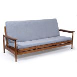 A 1960'S OR 70'S TEAK SOFA BED with open arms and standing on turned legs, 200cm wide x 86cm deep