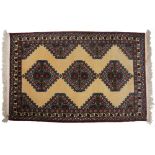 A MODERN LIGHT BROWN PERSIAN STYLE WOOLEN RUG with geometric decoration and three central diamond