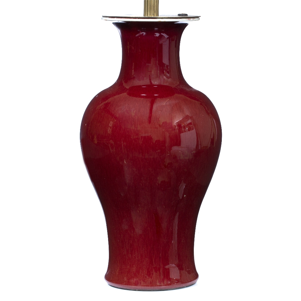 A TABLE LAMP converted from a Chinese oxblood red baluster vase, with flaring rim, 17cm diameter x