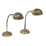 A PAIR OF MODERN BRASS TABLE LAMPS with shell moulded shades, adjustable stems and circular