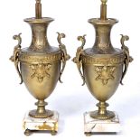 A PAIR OF GILT TABLE LAMPS in the form of Classical urns with marble bases, 47.5cm high to the light