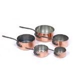 A GRADUATED SET OF FIVE FRENCH COPPER SAUCEPANS with wrought iron handles, the largest 18cm