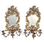 A PAIR OF 19TH CENTURY GILT METAL THREE BRANCH GIRANDOLE MIRRORS with cherub crests and acanthus