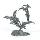 A BRONZE SCULPTURE DEPICTING A POD OF CIRCLING DOLPHINS 45cm wide x 43cm high