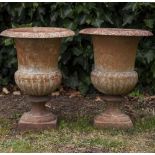 A PAIR OF CAST IRON CAMPANA URNS 31cm diameter x 42cm high (2)