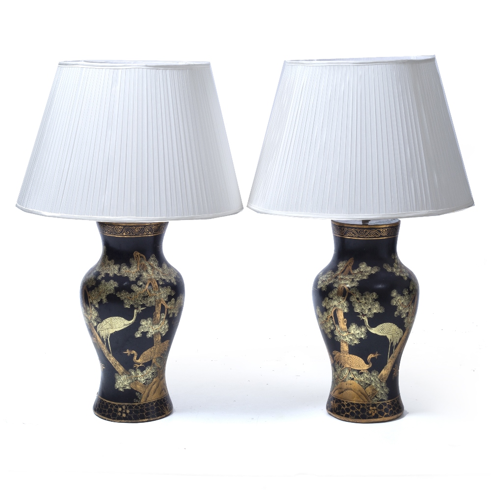 A PAIR OF CHINOISERIE LACQUERED TABLE LAMPS decorated with storks, each 55cm high excluding the