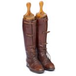 A SET OF BROWN LEATHER RIDING BOOTS with buckled front and complete with shoe trees, 30.5cm long