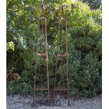 A PAIR OF WROUGHT IRON TRIANGULAR SECTION GARDEN OBELISKS with scroll finials, 41cm wide x 231cm