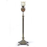 A BRASS STANDARD LAMP OIL LAMP of Corinthian column form on a stepped base and four paw feet,
