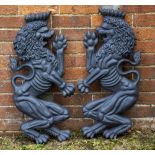 A PAIR OF GREY PAINTED CAST IRON LION CREST SUPPORTS each 38cm x 75cm