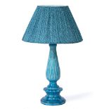 A TURQUOISE GLAZED POTTERY TABLE LAMP the central column with leaf moulded decoration and with a