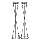 A PAIR OF EMPIRE STYLE WROUGHT IRON TORCHERES with arrow supports and ring bases, 34.5cm diameter