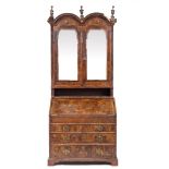 AN 18TH CENTURY AND LATER BUREAU BOOKCASE with double arched top above mirrored doors enclosing