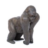 A LATE 20TH CENTURY BRONZED CAST RESIN SCULPTURE of a gorilla, approximately 32cm long x 37cm high