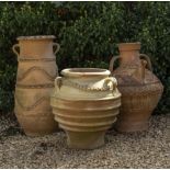 A GROUP OF THREE CONTINENTAL TERRACOTTA JARS with trailing decoration, the largest 77cm high (3)