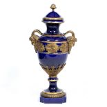 A 19TH CENTURY SEVRES STYLE BLUE GROUND POTTERY VASE AND COVER of large proportions with ormolu