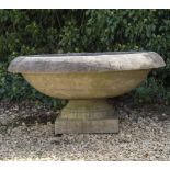 A TURNED STONE SHALLOW URN OR FOUNTAIN on a turned base, 100cm diameter x 50cm high