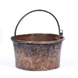 AN OLD COPPER LOG BIN with looping wrought iron handle, 54cm diameter x 30cm high