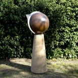 A GARDEN SUNDIAL BY DAVID HARBER in the form of a copper sphere with engraved lions and shaped