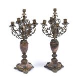 A PAIR OF GILT METAL FIVE BRANCH CANDELABRA with scrolling acanthus leaf arms, an oval marble column