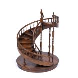 A STAINED WOODEN MODEL OF A SPIRAL STAIRCASE 46cm diameter x 60cm high