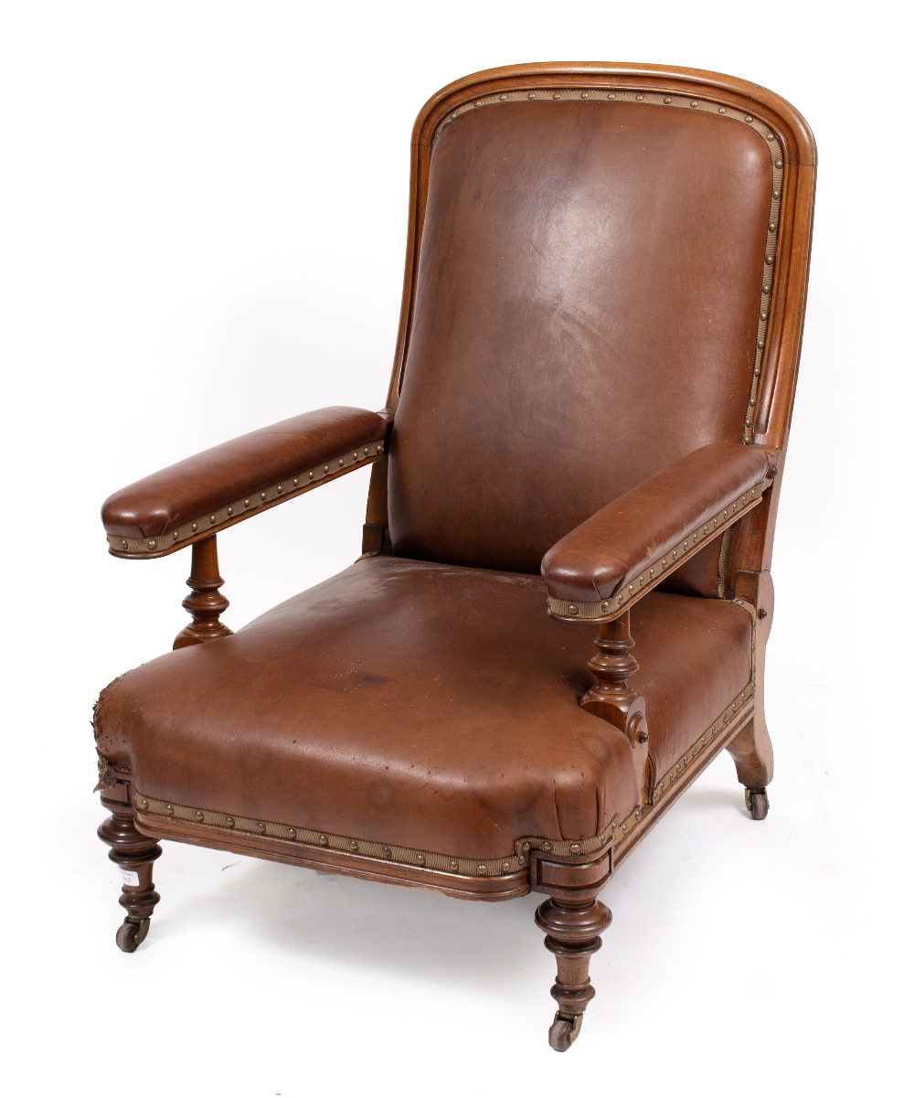 A VICTORIAN WALNUT FRAMED RECLINING ARMCHAIR with brown leather upholstery, patent R Reid & Co Kilm,