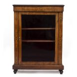 A VICTORIAN WALNUT PIER CABINET with single glazed door and decorative inlay, all standing on turned