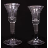 AN 18TH CENTURY WINE GLASS with bell shaped bowl, plain stem and folded foot, 16.5cm high together