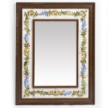 A WOODEN FRAMED MIRROR with decorative floral ceramic tiles, 70cm x 90cm