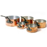 A GRADUATED SET OF FIVE FRENCH COPPER SAUCEPANS with steel handles, the largest 20.5cm diameter