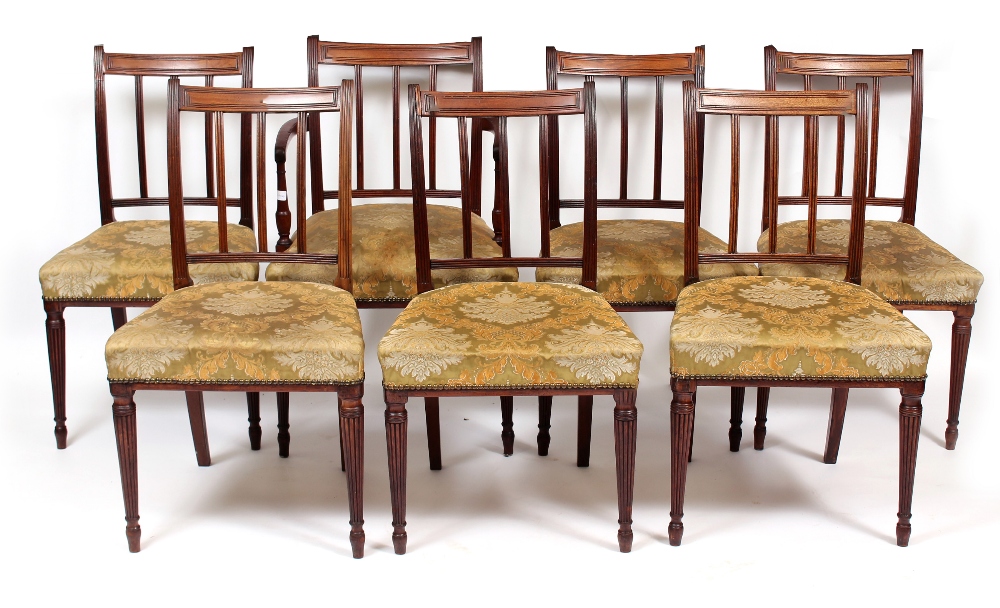 A SET OF SEVEN GEORGIAN STYLE MAHOGANY DINING CHAIRS with reeded bar backs, vertical splats and