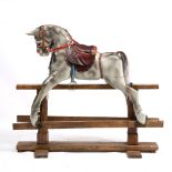 AN EARLY TO MID 19TH CENTURY PAINTED WOODEN ROCKING HORSE on a pine stand, overall 132cm wide x