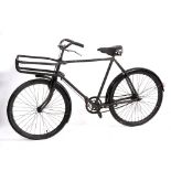 A BLACK PAINTED DELIVERY BICYCLE with Dunlop seat and front pannier rack, 20" frame