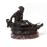 A BRONZE FIGURE OF A NATIVE AMERICAN INDIAN seated in a canoe and with bow and spear, impressed '