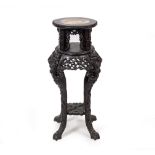 A 19TH CENTURY CHINESE CARVED PADAUK WOOD STAND with a marble inset top, 38cm diameter x 84cm high