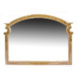 A CREAM AND GILT PAINTED WALL MIRROR with an arching top, 152cm wide x 111cm high