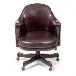 A DARK RED LEATHER UPHOLSTERED SWIVELLING ARMCHAIR 70cm wide x 65cm deep x 92cm high