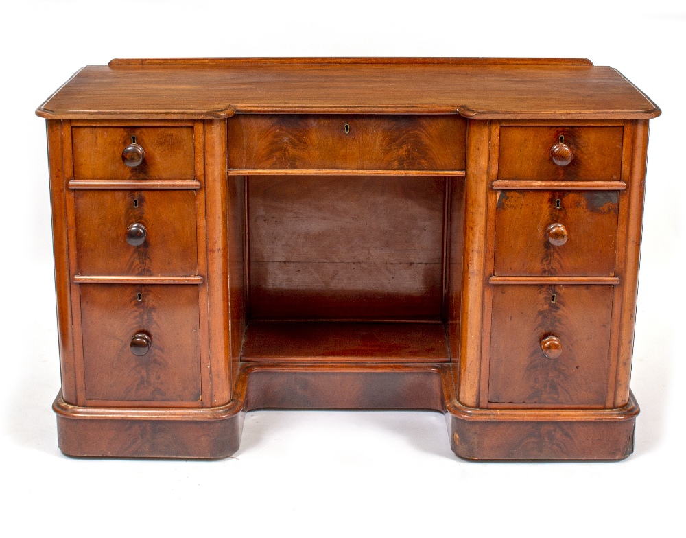 A VICTORIAN MAHOGANY INVERSE BREAK FRONT DRESSING TABLE OR DESK with central kneehole and seven