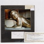 A SHIRLEY EATON SIGNATURE together with a photo still from the film 'Goldfinger'
