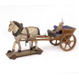 AN EARLY 20TH CENTURY CARVED PAINTED WOODEN TOY HORSE AND WAGON mounted on wheels, 24cm long