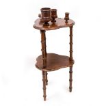 AN EARLY 20TH CENTURY TWO TIER TOBACCO TABLE with turned treen bowls and faux bamboo supports,