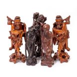 A GROUP OF FIVE ORIENTAL CARVED HARDWOOD FIGURES the largest 35cm high (5)