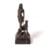 A BRONZE FIGURE OF A SCANTILY CLAD EGYPTIANESQUE FEMALE, a seated dog at her feet, the base