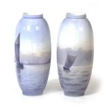 A NEAR PAIR OF ROYAL COPENHAGEN PORCELAIN VASES each decorated with sailing boats at sea, one