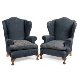 A PAIR OF GEORGIAN STYLE BLUE UPHOLSTERED WING BACK ARMCHAIRS with cabriole legs and paw feet, 105cm