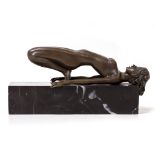 A BRONZE FIGURE OF A FEMALE NUDE in reclining position, on a black marble plinth base, 11.5cm high