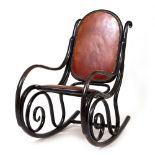 AN EARLY 20TH CENTURY EBONISED BENTWOOD ROCKING CHAIR with brown leather upholstery, 49cm wide x