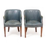 A PAIR OF BLUE LEATHER UPHOLSTERED SIDE CHAIRS with arching backs, serpentine fronts to the seats